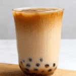 Hokkaido milk tea in clear mug on marble for recipe card Optimized for recipe cards, this image keeps the focus on the final, comforting cup of Hokkaido milk tea.