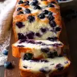 Loaf of Blueberry Cream Cheese Bread with fresh blueberries