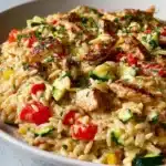 Boursin Orzo Bake with Chicken and Vegetables served in a baking dish
