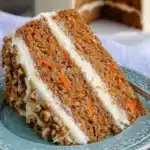 Slice of browned butter carrot cake with cream cheese frosting on a plate