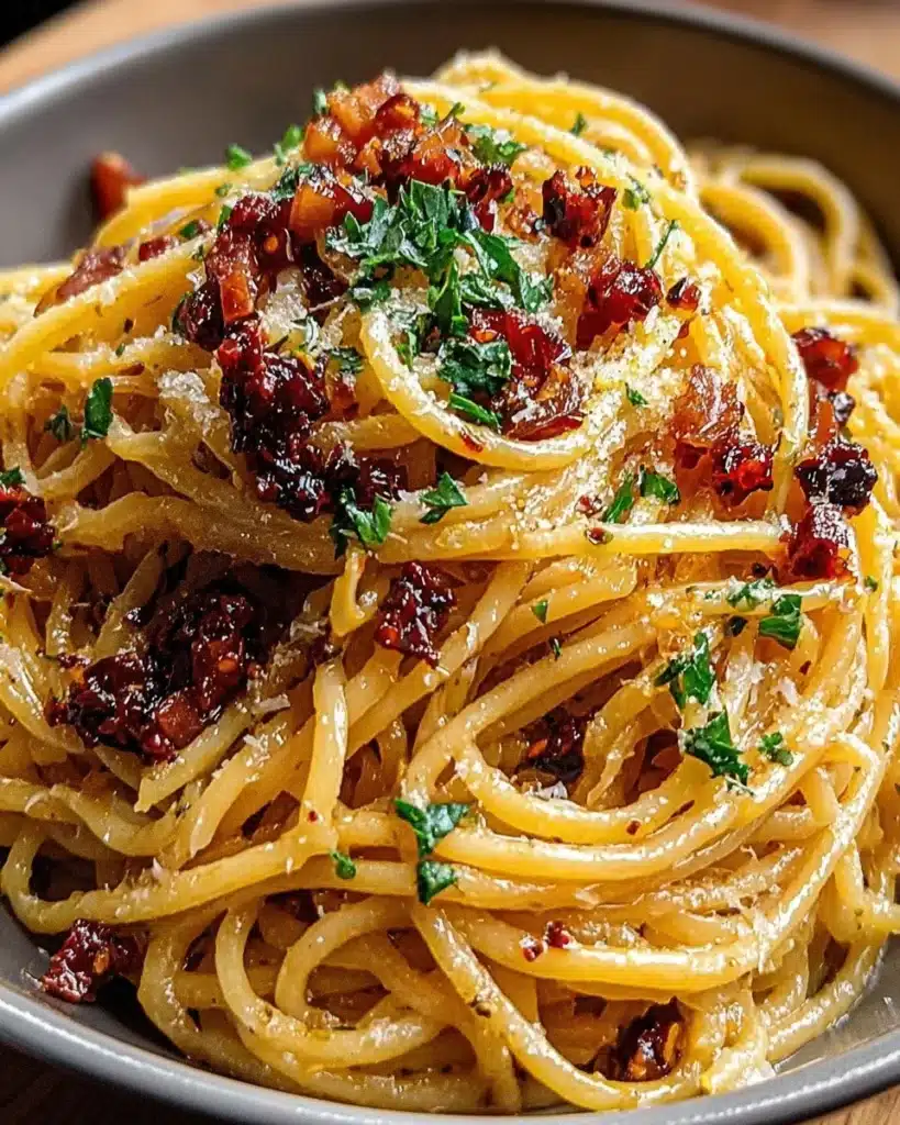 Delicious caramelized onion pasta topped with chili oil and herbs.