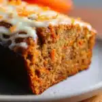 Delicious Carrot Cake Banana Bread slice on a wooden board