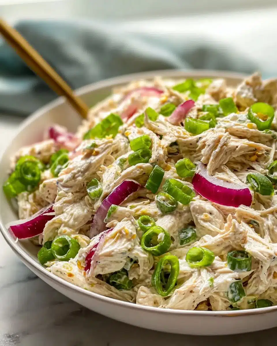 A fresh and colorful chicken salad with vegetables and dressing