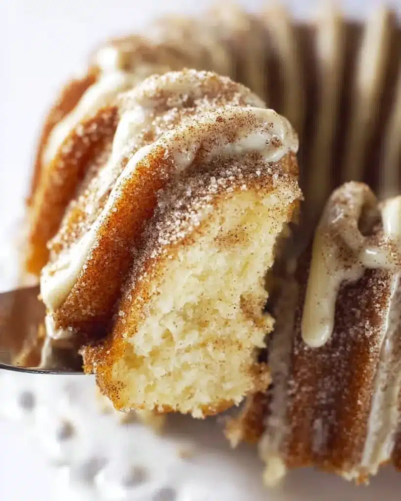 Moist and fluffy Churro Cake topped with cinnamon and sugar