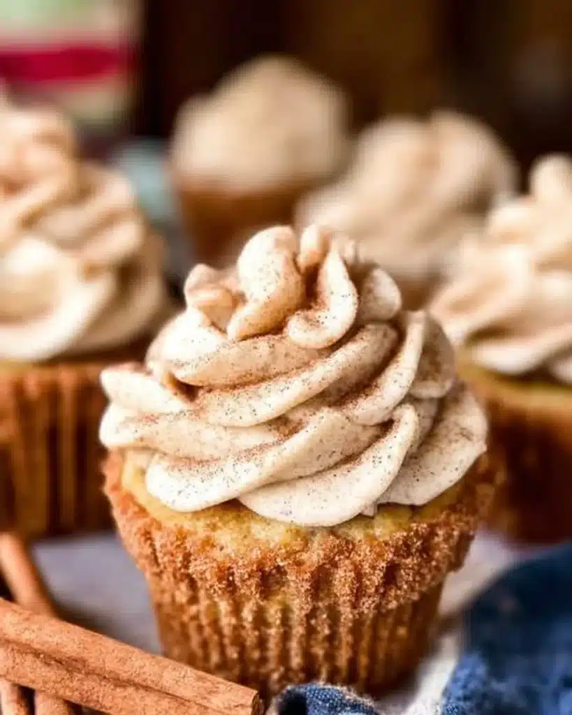 Delicious churro cupcakes topped with cinnamon sugar and cream frosting.