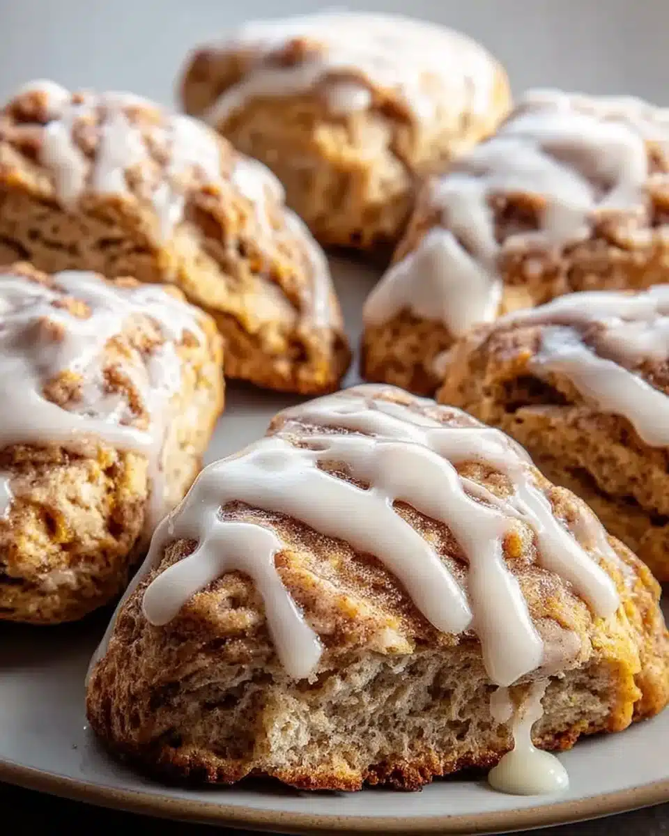 Freshly baked cinnamon bun scones topped with icing