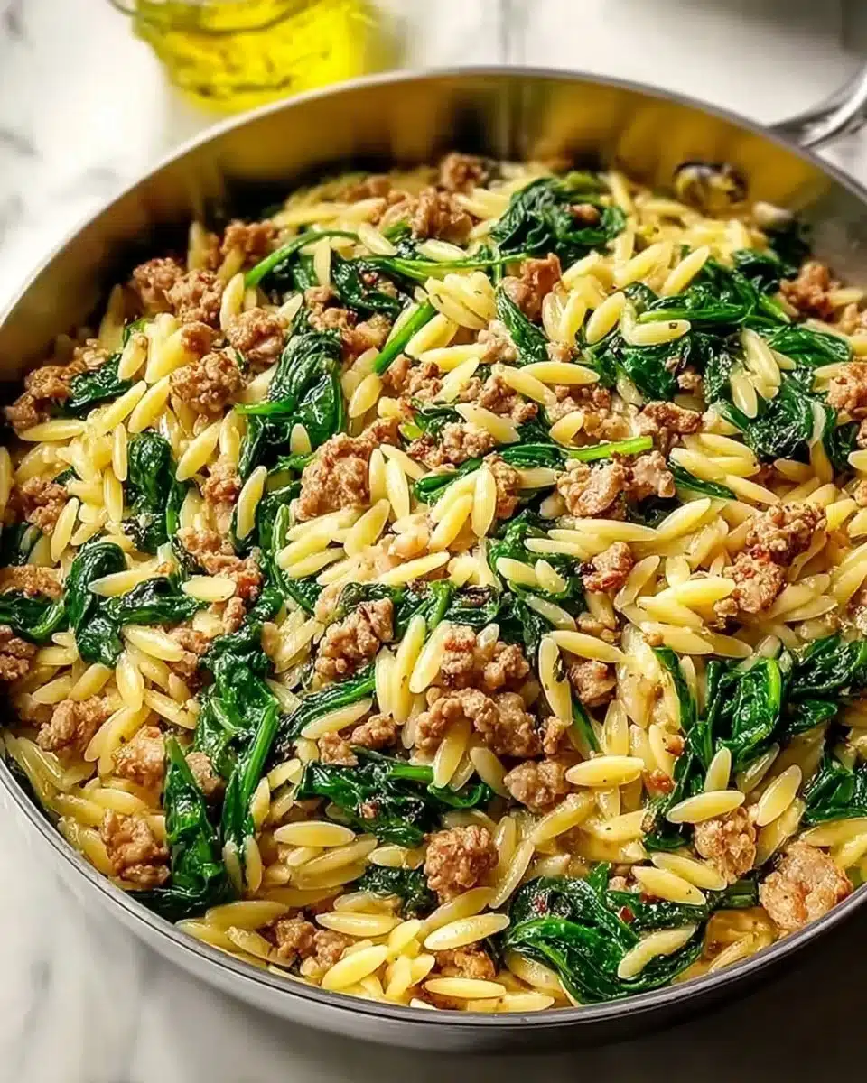 Ground turkey spinach orzo dish garnished with herbs and served in a bowl