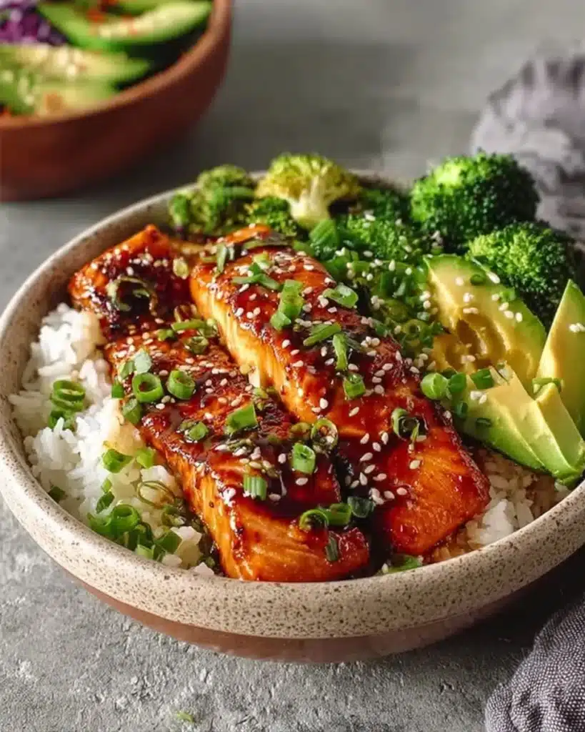 Honey glazed salmon bowl with fresh vegetables and rice