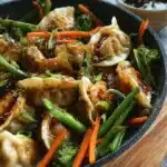 A colorful potsticker stir fry featuring vibrant vegetables and crispy dumplings.