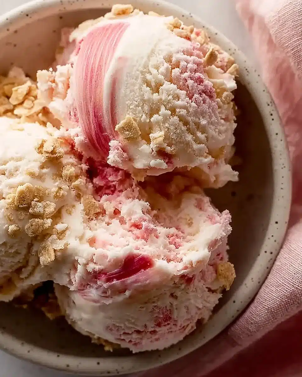 Homemade rhubarb vanilla ice cream served in a bowl with fresh rhubarb