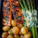 Salmon fillet served with roasted baby potatoes and asparagus