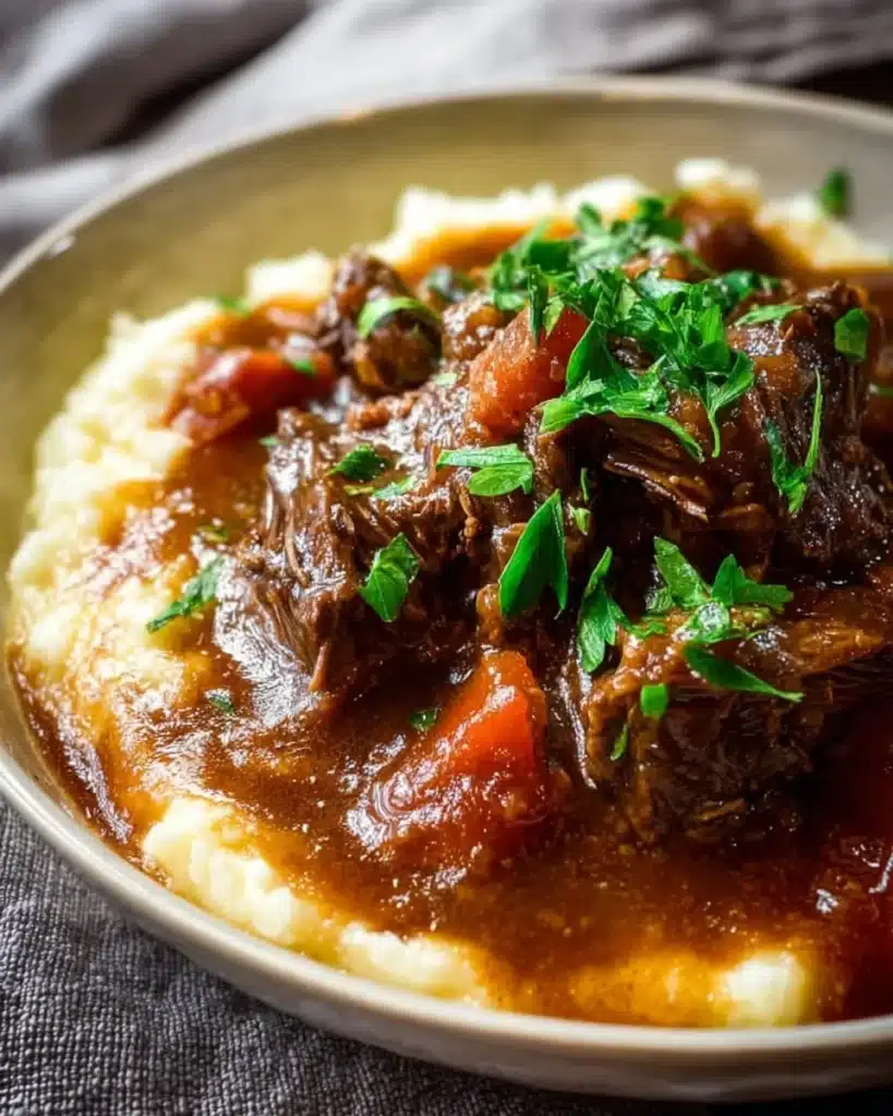 Slow Cooker Beef Manhattan dish served with sauce and vegetables