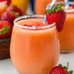 Strawberry Mango Margarita cocktail served in a glass with fresh fruit garnish.