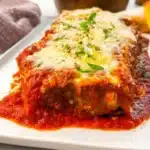 Delicious stuffed Italian meatloaf served with sauce and herbs