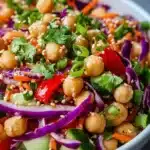 Bowl of colorful Thai Chickpea Salad with fresh vegetables and herbs