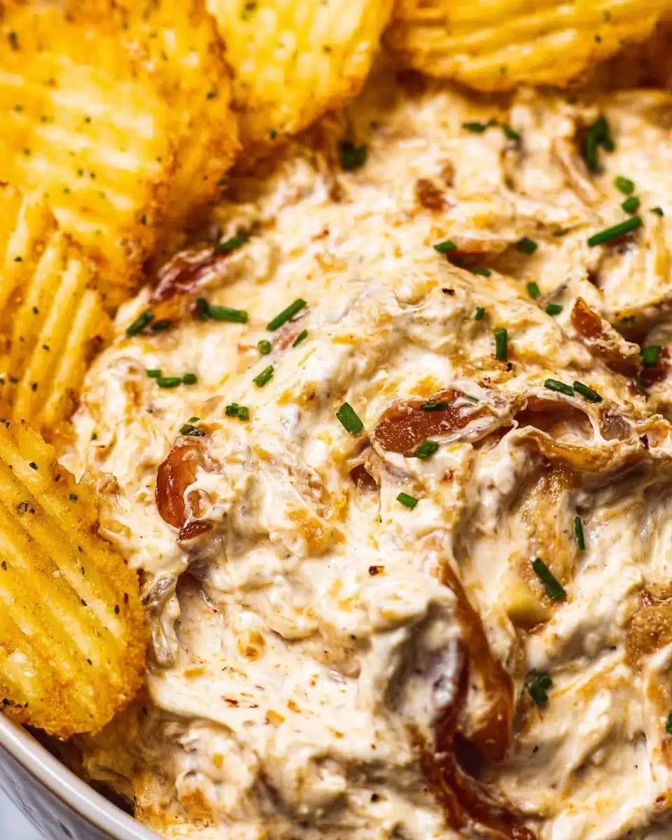 Delicious bowl of homemade French Onion Dip with crispy chips on the side