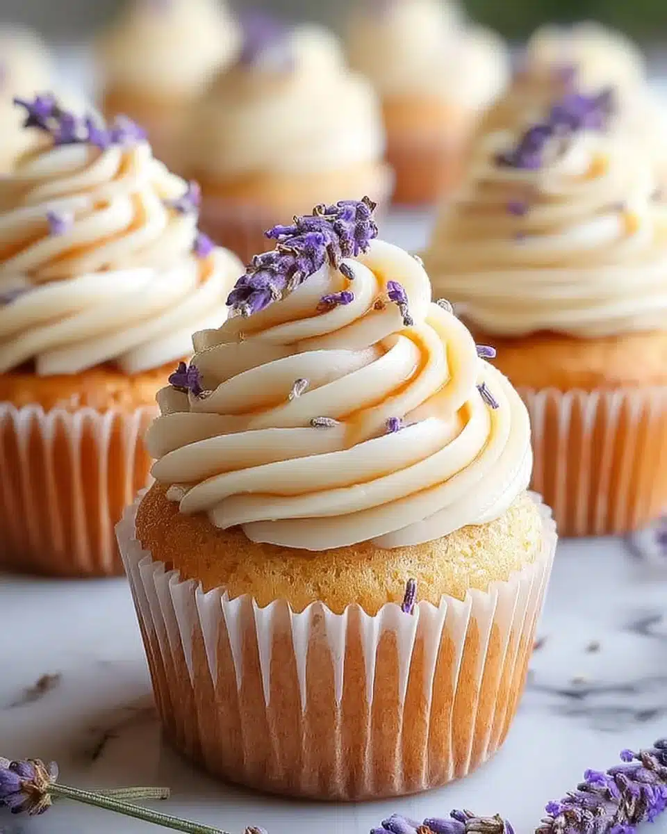 Lavender Honey Cupcakes topped with honey glaze and lavender sprigs