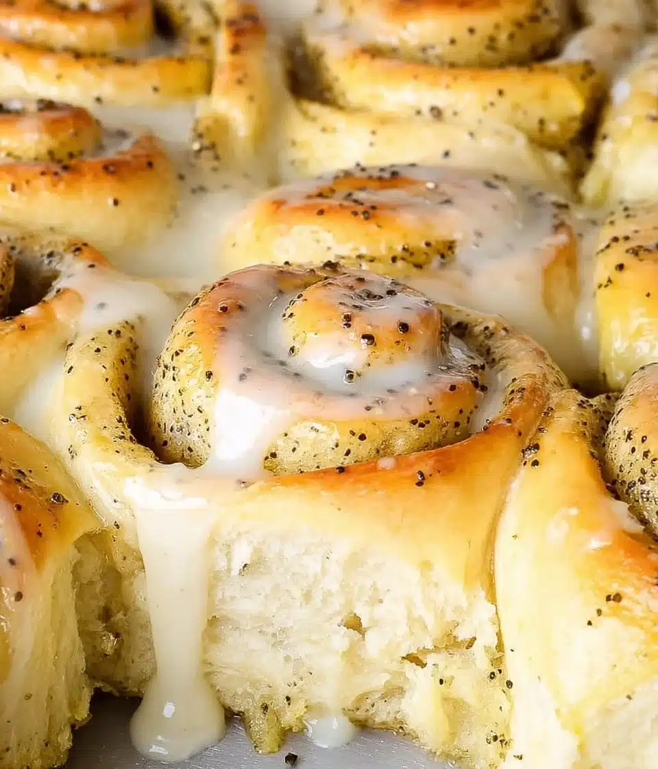 Freshly baked lemon poppy seed rolls with a golden crust and lemon glaze