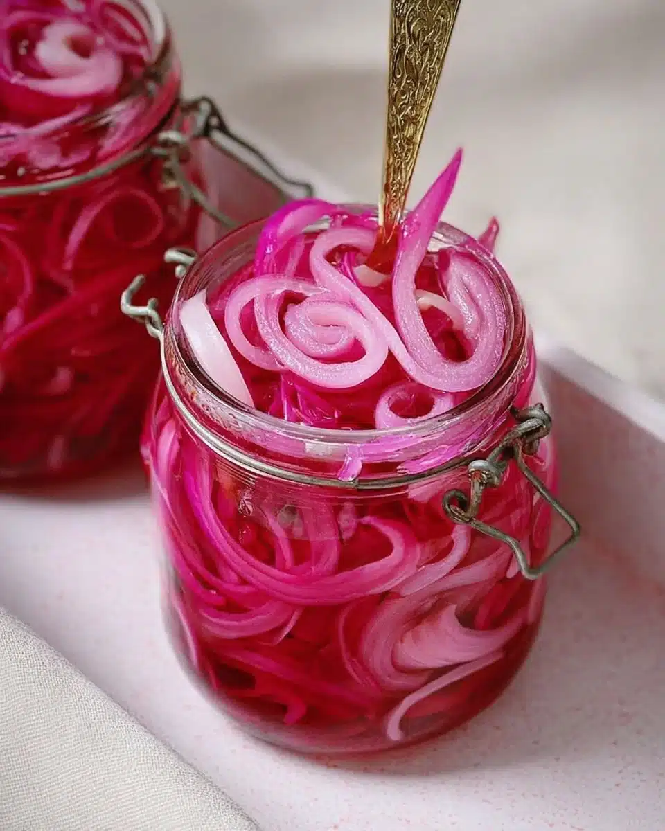 Homemade pickled red onions in a jar with spices