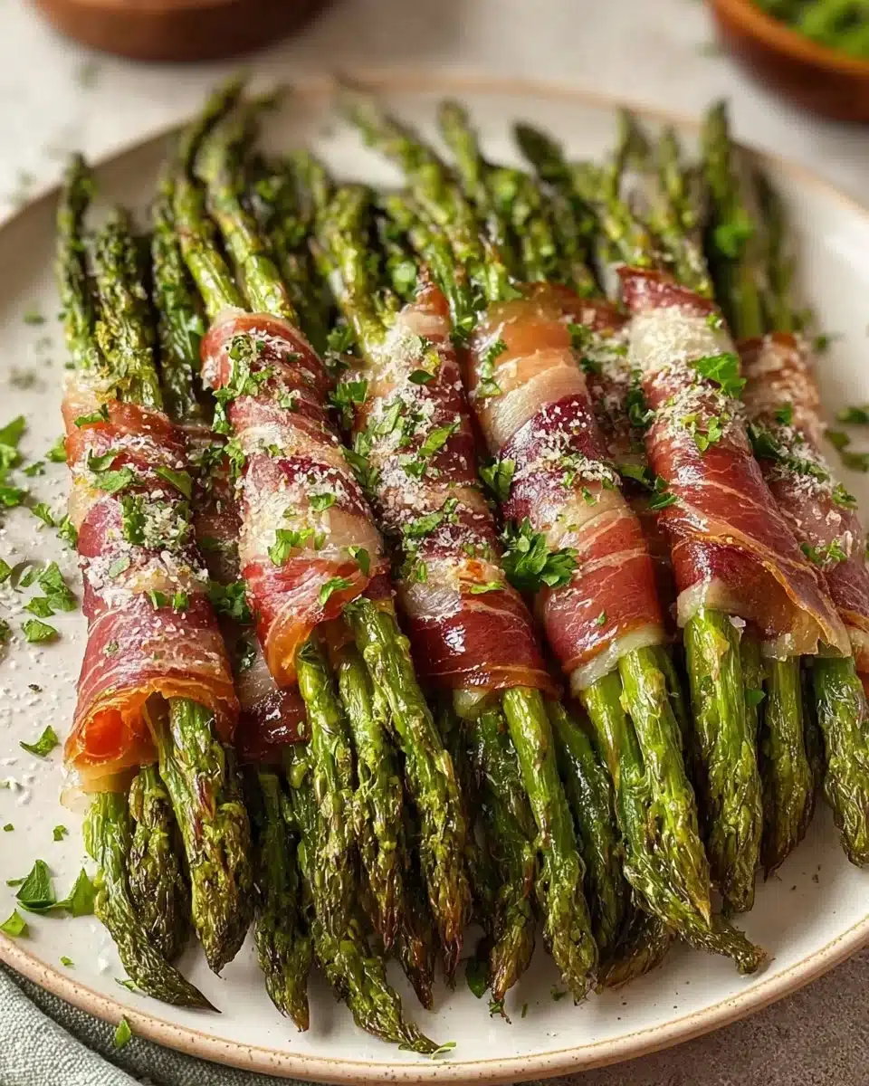 Prosciutto wrapped asparagus served on a plate as a gourmet appetizer