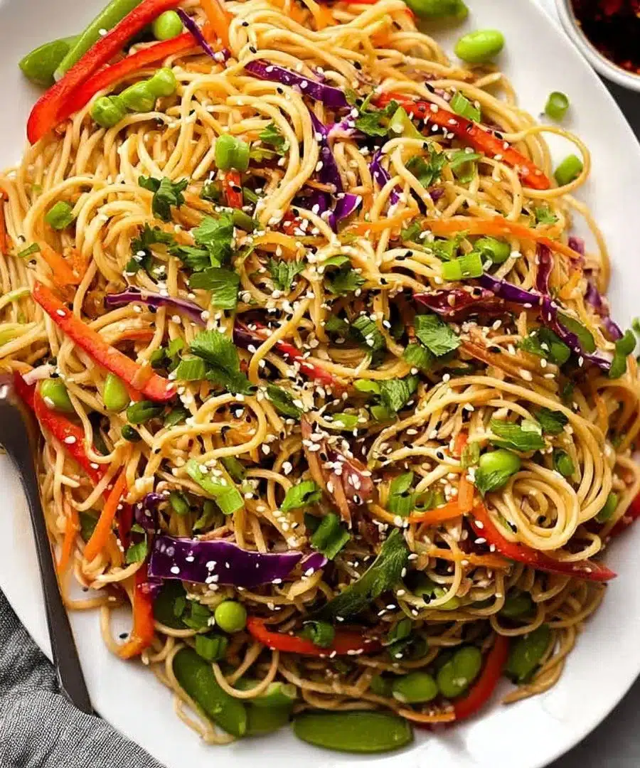 A vibrant bowl of Sesame Noodle Salad with colorful vegetables and sesame dressing