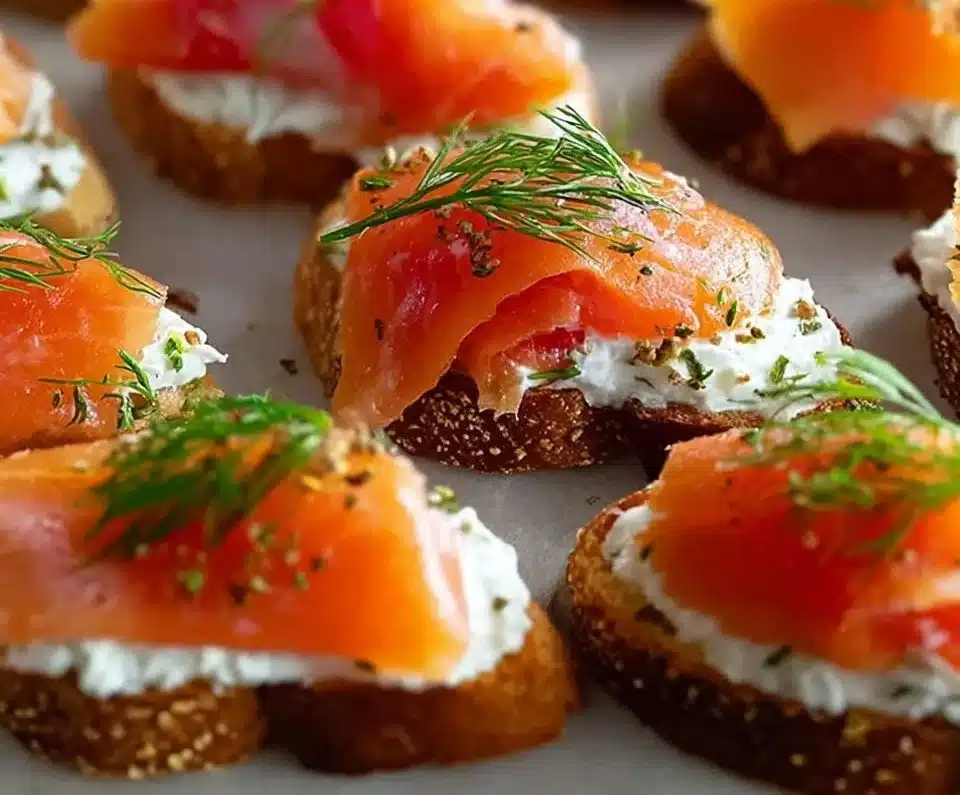 Delicious smoked salmon crostini topped with cream cheese and herbs