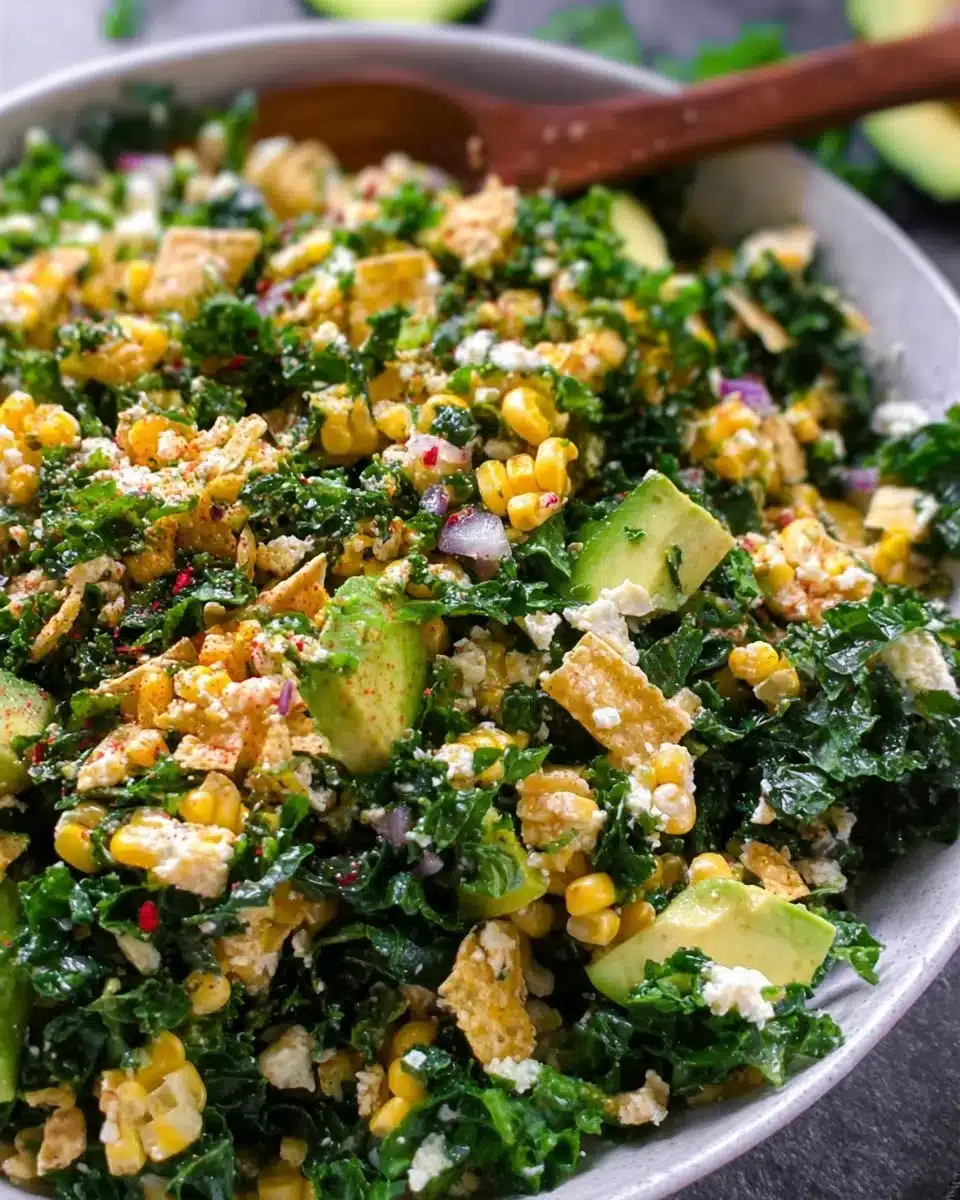 A colorful bowl of Street Corn Kale Salad topped with fresh ingredients and spices.