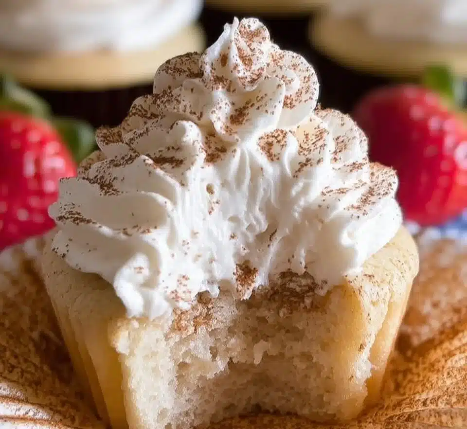 Three Milks Cupcakes topped with creamy frosting and fresh fruit