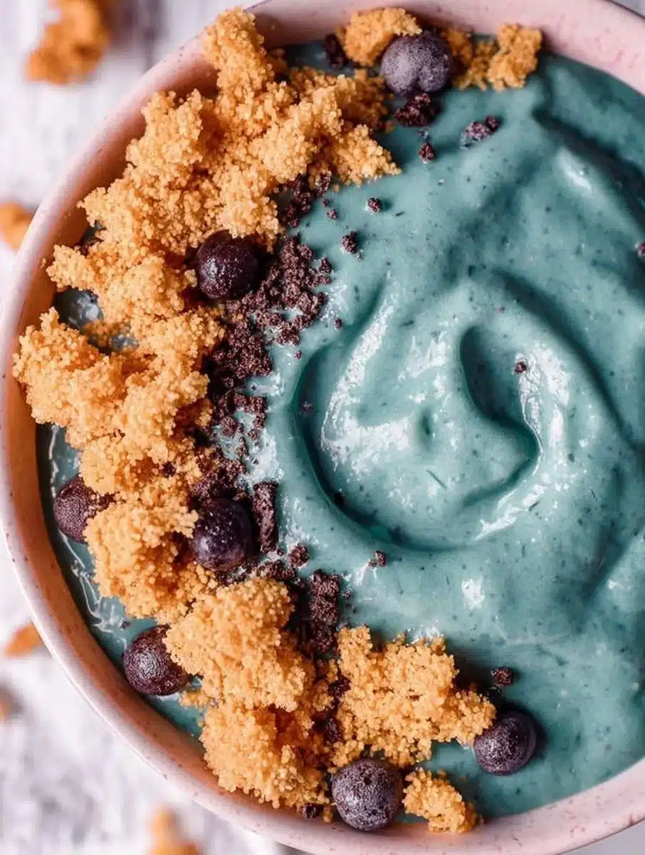 Colorful Cookie Monster smoothie bowl topped with cookies and blue smoothie