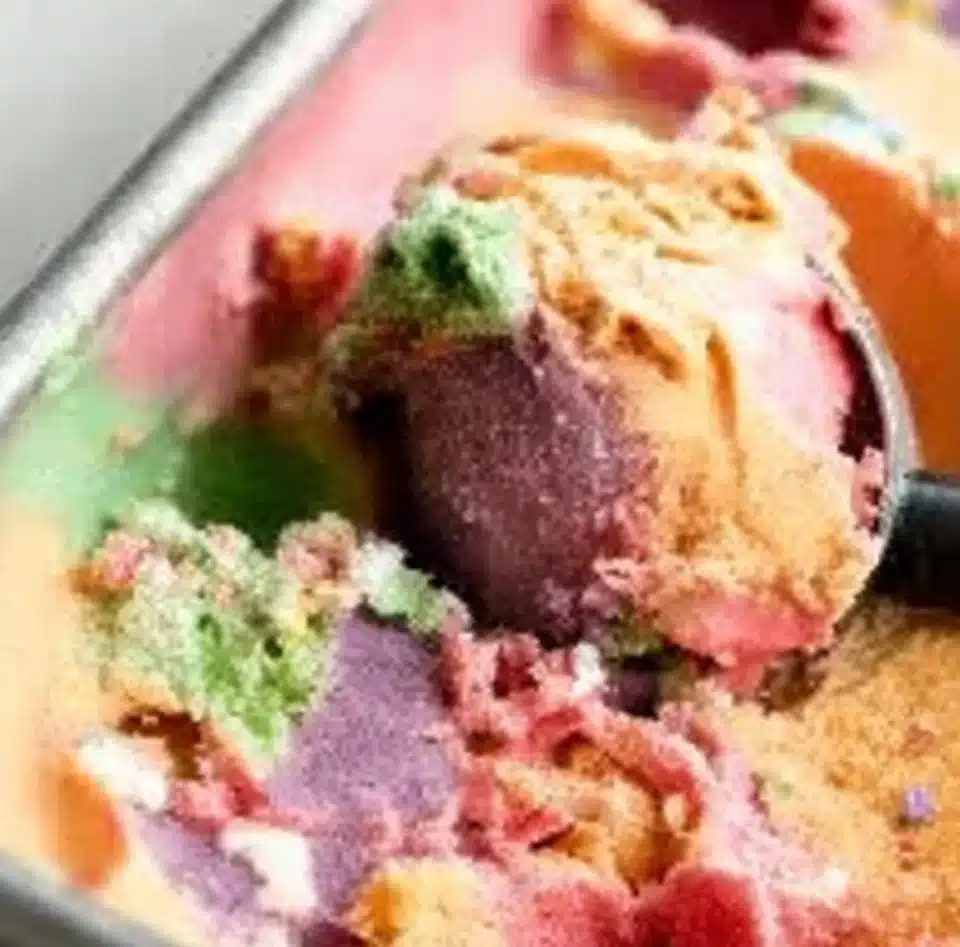 A bowl of colorful Rainbow Sherbet served in a dish.