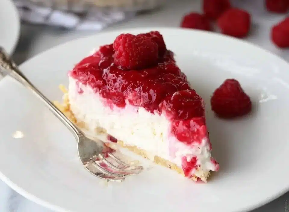 Delicious slice of raspberry cream pie with fresh raspberries on top
