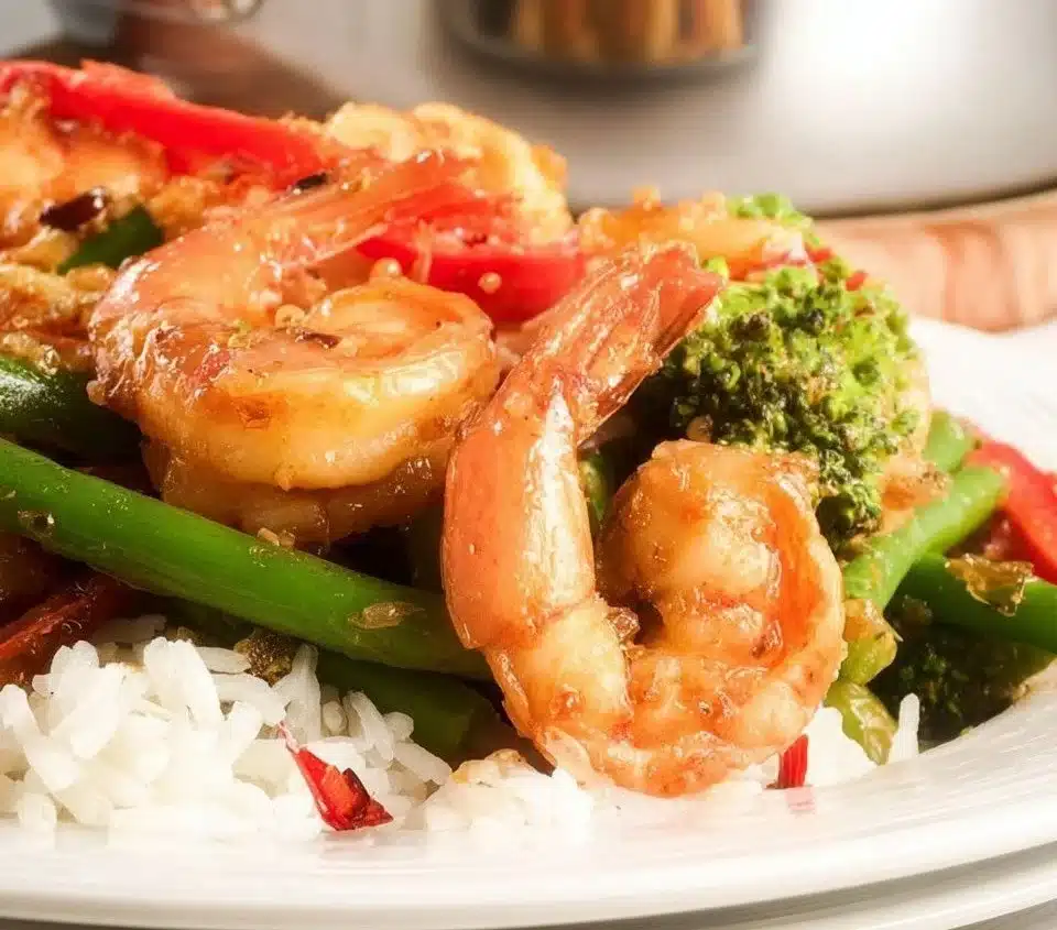 Shrimp and green bean stir fry served in a bowl with colorful vegetables