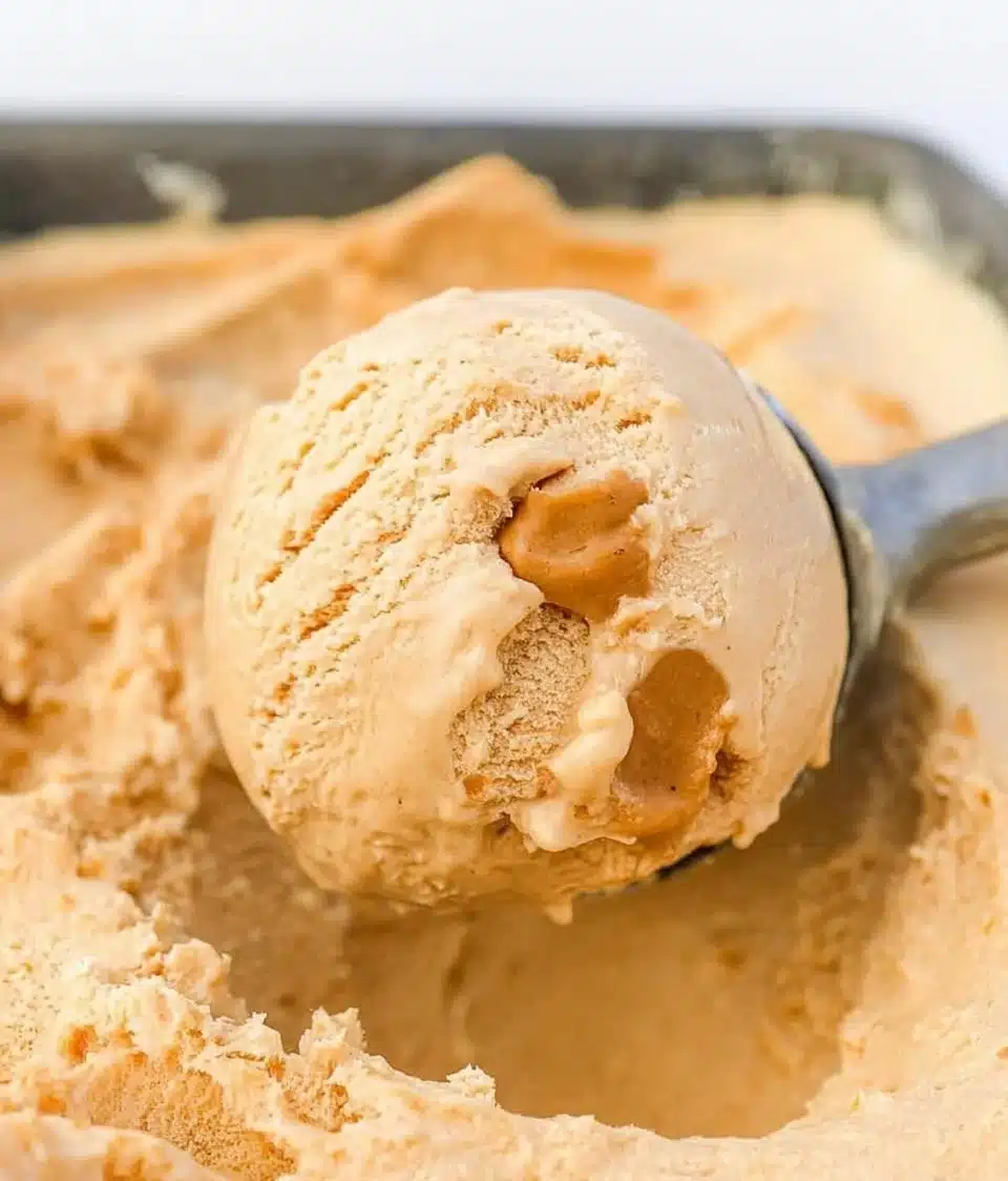 A bowl of homemade peanut butter ice cream with a drizzle of chocolate