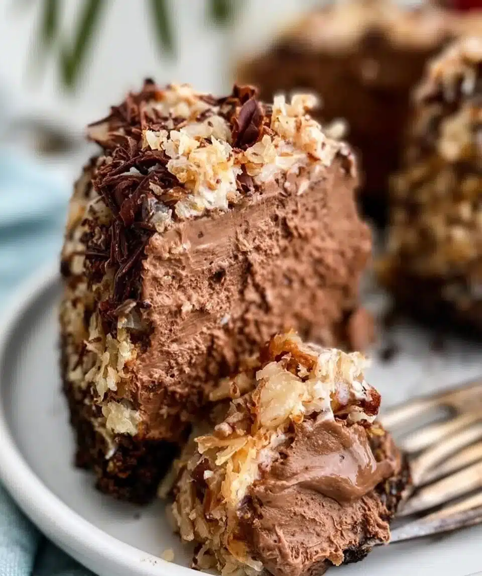 Slice of German Chocolate Cheesecake with chocolate drizzle and coconut topping