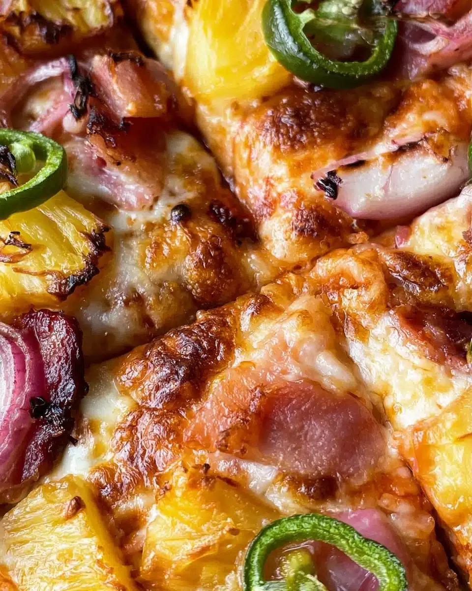 Delicious Hawaiian Pizza topped with pineapple and ham on a wooden table.