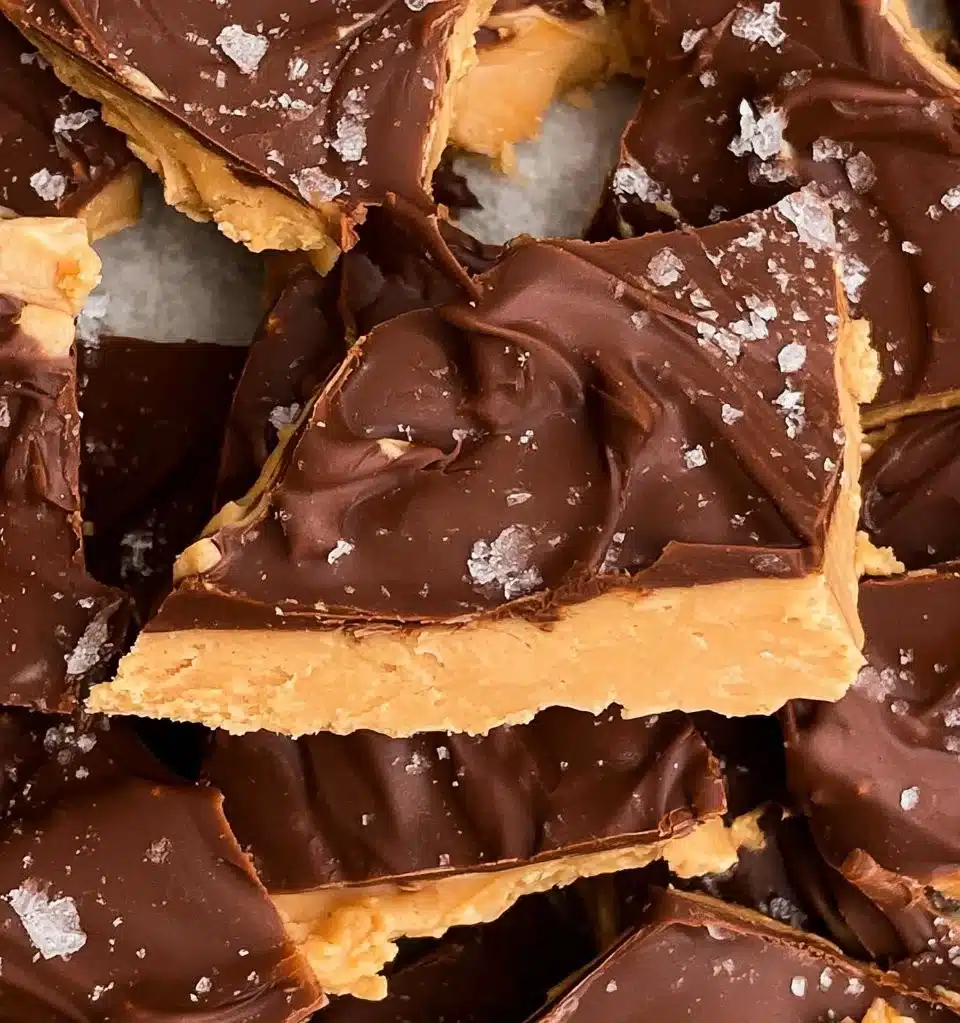 Peanut Butter Chocolate Greek Yogurt Bark on a plate, topped with nuts