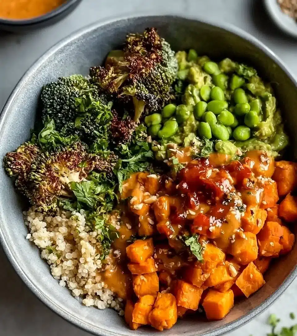 Peanut Sweet Potato Buddha Bowl topped with fresh vegetables and a tasty dressing