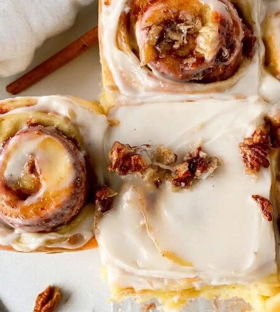 Homemade apple pecan cinnamon rolls topped with cream cheese frosting