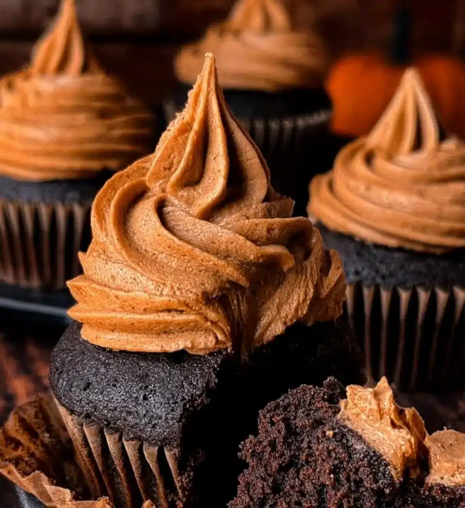 Chocolate Pumpkin Cupcakes topped with creamy frosting and sprinkled with chocolate chips.