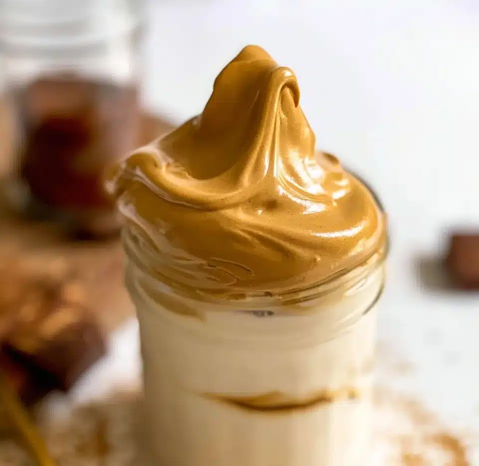 Delicious cup of Dalgona Coffee topped with whipped cream
