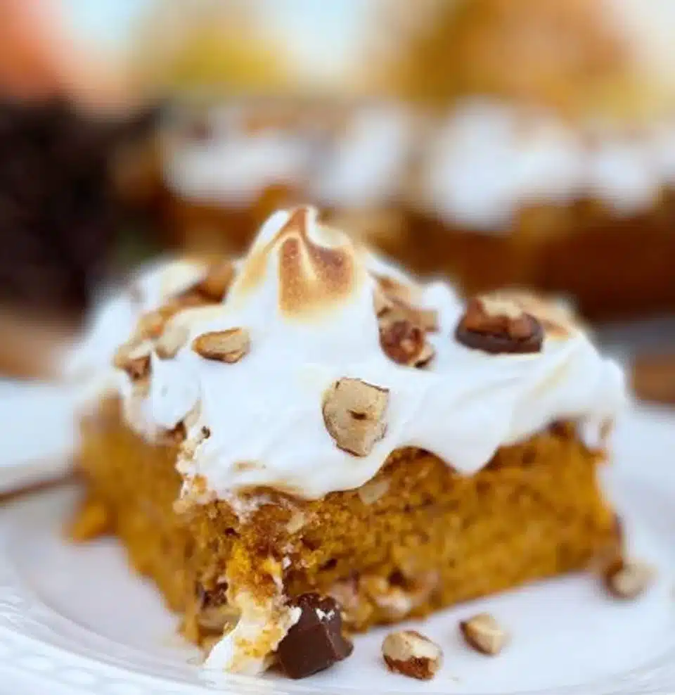 Delicious Pumpkin Poke Cake topped with creamy frosting and pumpkin spices